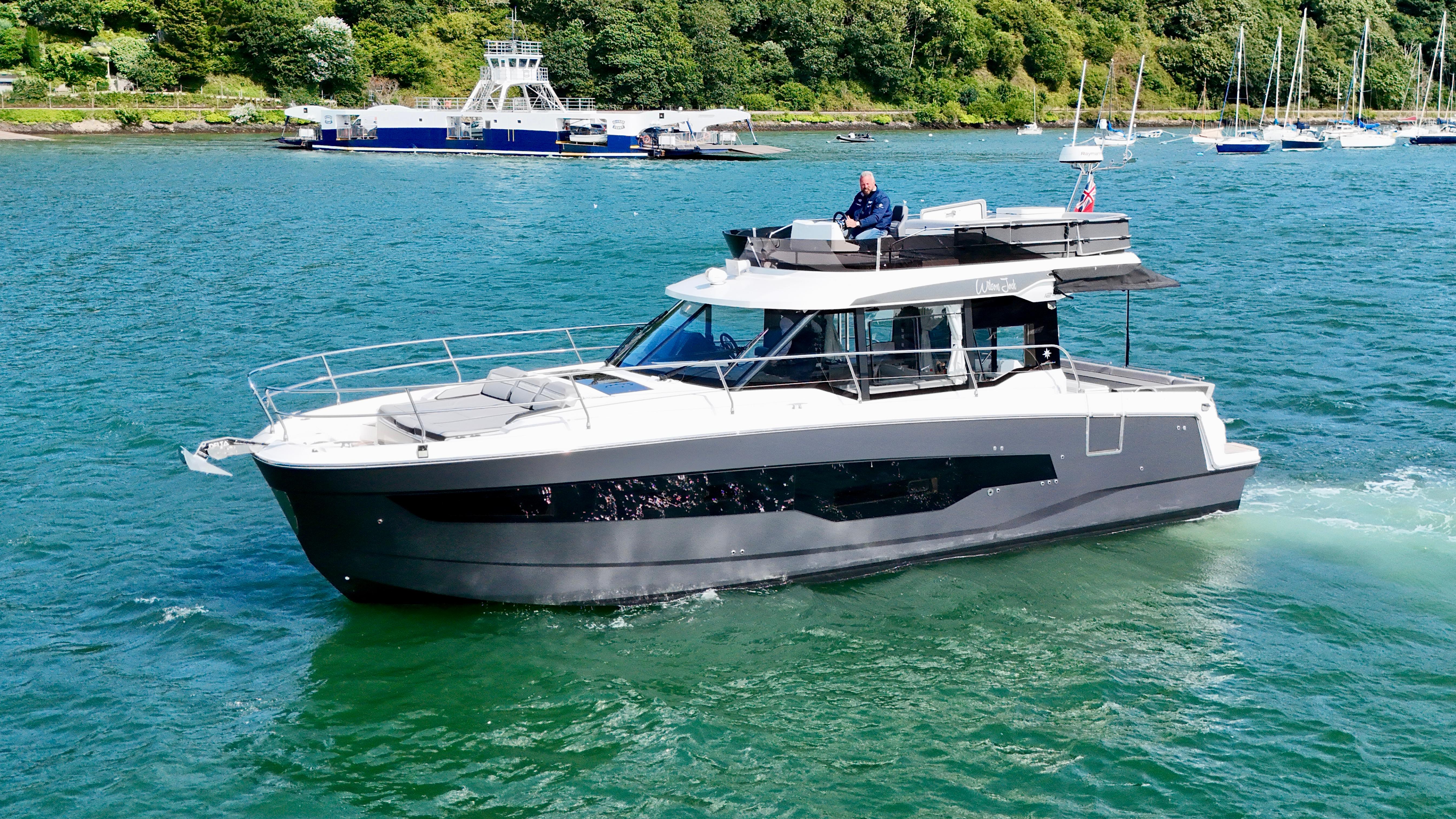 Jeanneau Merry Fisher 1295 Flybridge 2024 Jeanneau Merry Fisher 1295 Flybridge cruising on a scenic waterway.
