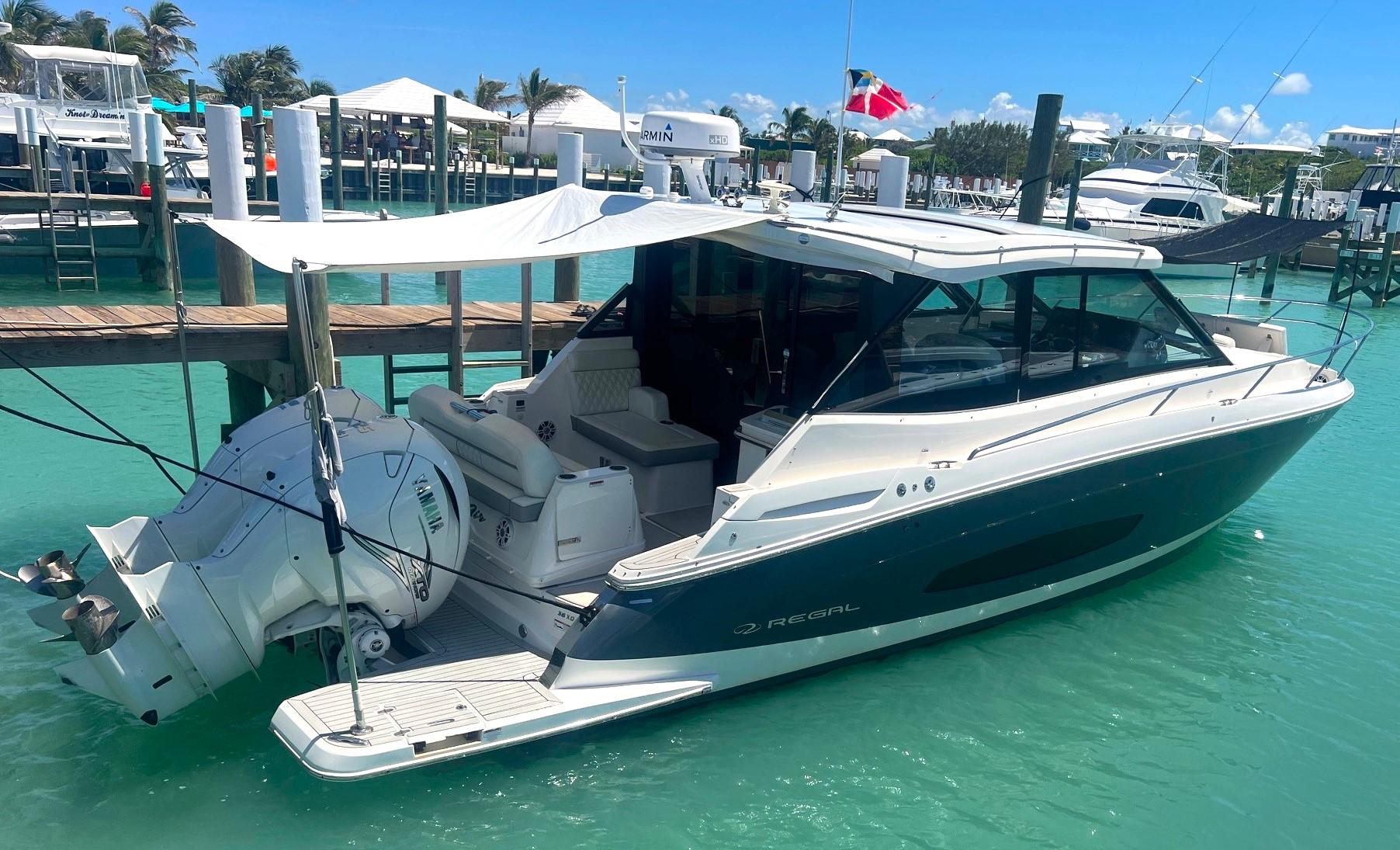 Regal 36 XO 2023 Regal 36 XO boat docked in a marina with turquoise water.