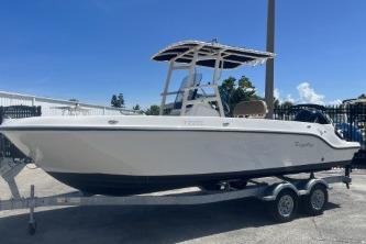 Trophy T22 2022 Trophy T22 boat on trailer, white hull, parked outdoors under clear blue sky.