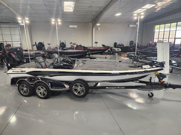Ranger Z521R 2024 Ranger Z521R boat in showroom, sleek design, triple-axle trailer.