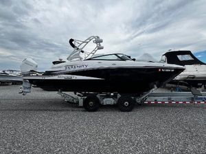 Monterey M-65 2021 Monterey M65 boat on trailer, overcast sky, side view.
