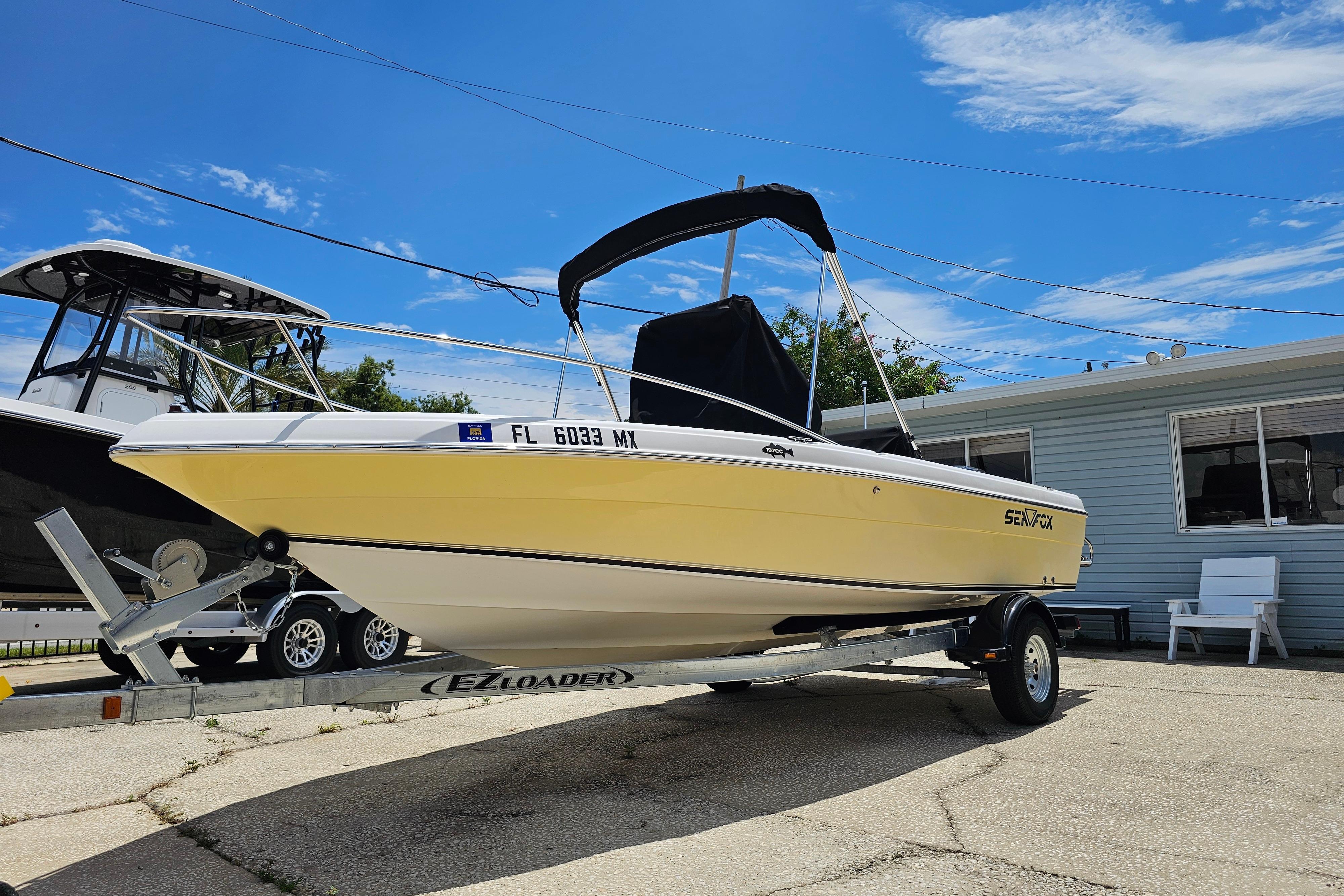 Sea Fox 197CC Pro Series 2005 Sea Fox 197CC Pro Series boat on trailer, parked outdoors under blue sky.