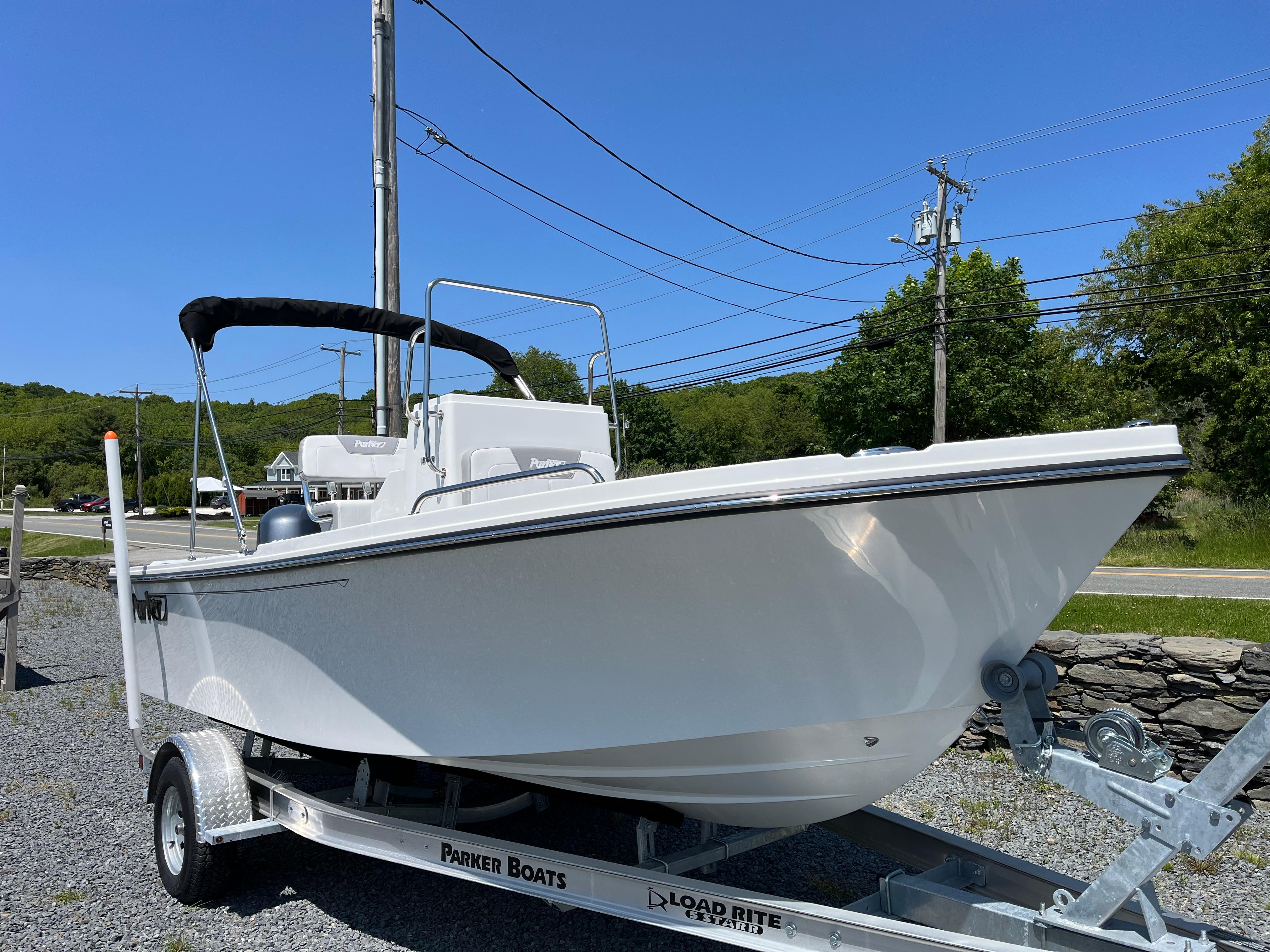 Parker 18SE Center Console 2025 Parker 18SE Center Console boat on trailer, parked outdoors under clear blue sky.