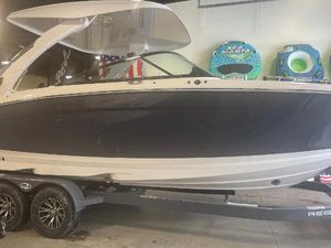 Regal LS9 2025 Regal LS9 boat on trailer in showroom with water sports equipment.