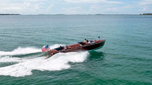 Custom Hugh Saint 34 Grand Prix Custom 1995 Hugh Saint 34 Grand Prix boat cruising on open water with American flag.