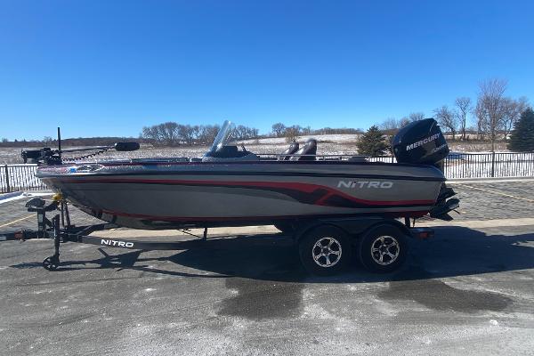 Nitro ZV 18 2018 Nitro ZV 18 boat on trailer, parked outdoors under clear blue sky.