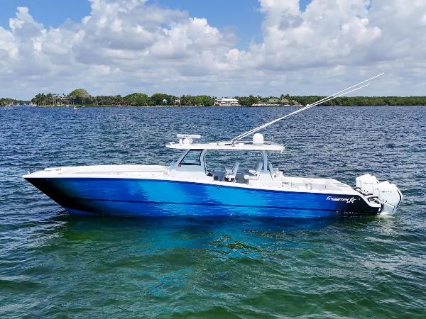 Freeman 47 2023 Freeman 47 boat on water, blue hull, clear sky, calm sea.