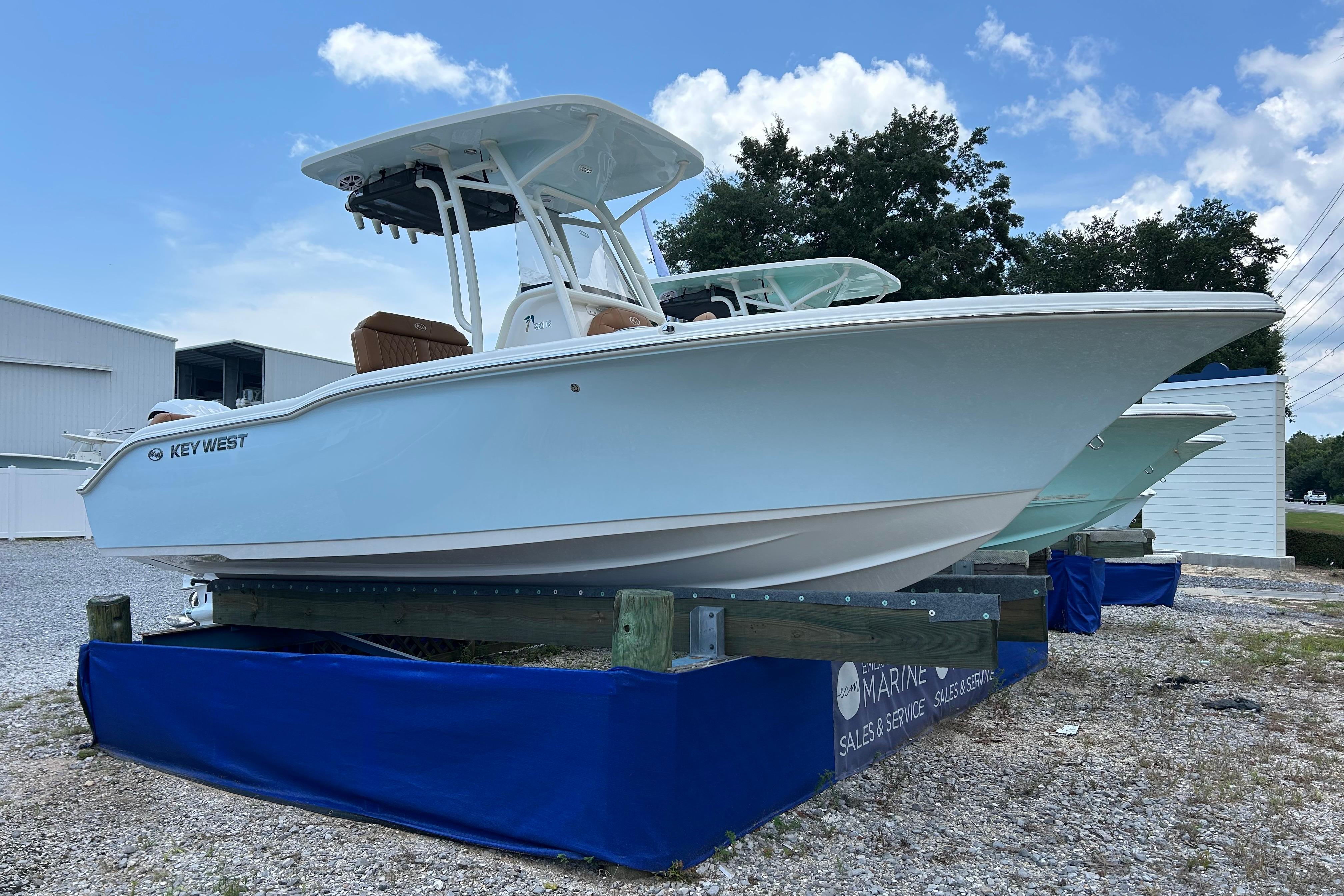 Key West 239 FS 2026 Key West 239 FS boat displayed outdoors on a stand, under a clear sky.