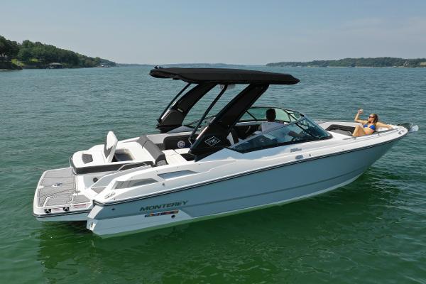 Monterey 298SS 2023 Monterey 298SS boat on a lake with a person relaxing onboard.