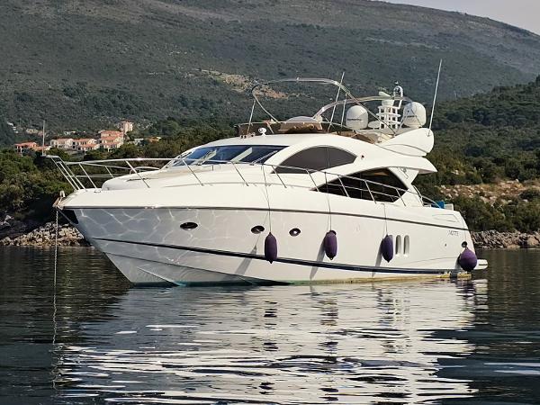 Sunseeker Manhattan 60 2008 Sunseeker Manhattan 60 yacht on calm water, with scenic hillside backdrop.
