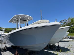 Parker 2400 Center Console 2024 Parker 2400 Center Console boat displayed outdoors on stands under clear blue sky.