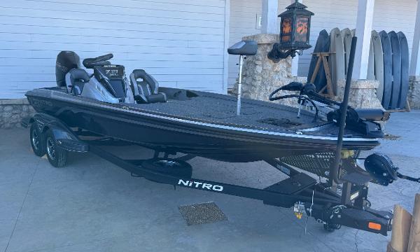 Nitro Z21 XL 2025 Nitro Z21 XL fishing boat on trailer, parked outdoors.