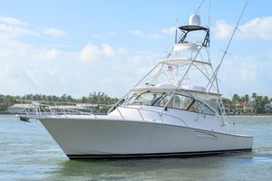 Viking 52 Open 2015 Viking 52 Open yacht cruising on a sunny day near coastal homes.