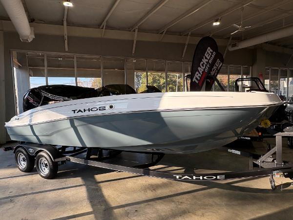 Tahoe T21 2024 Tahoe T21 boat on trailer in showroom, side view.