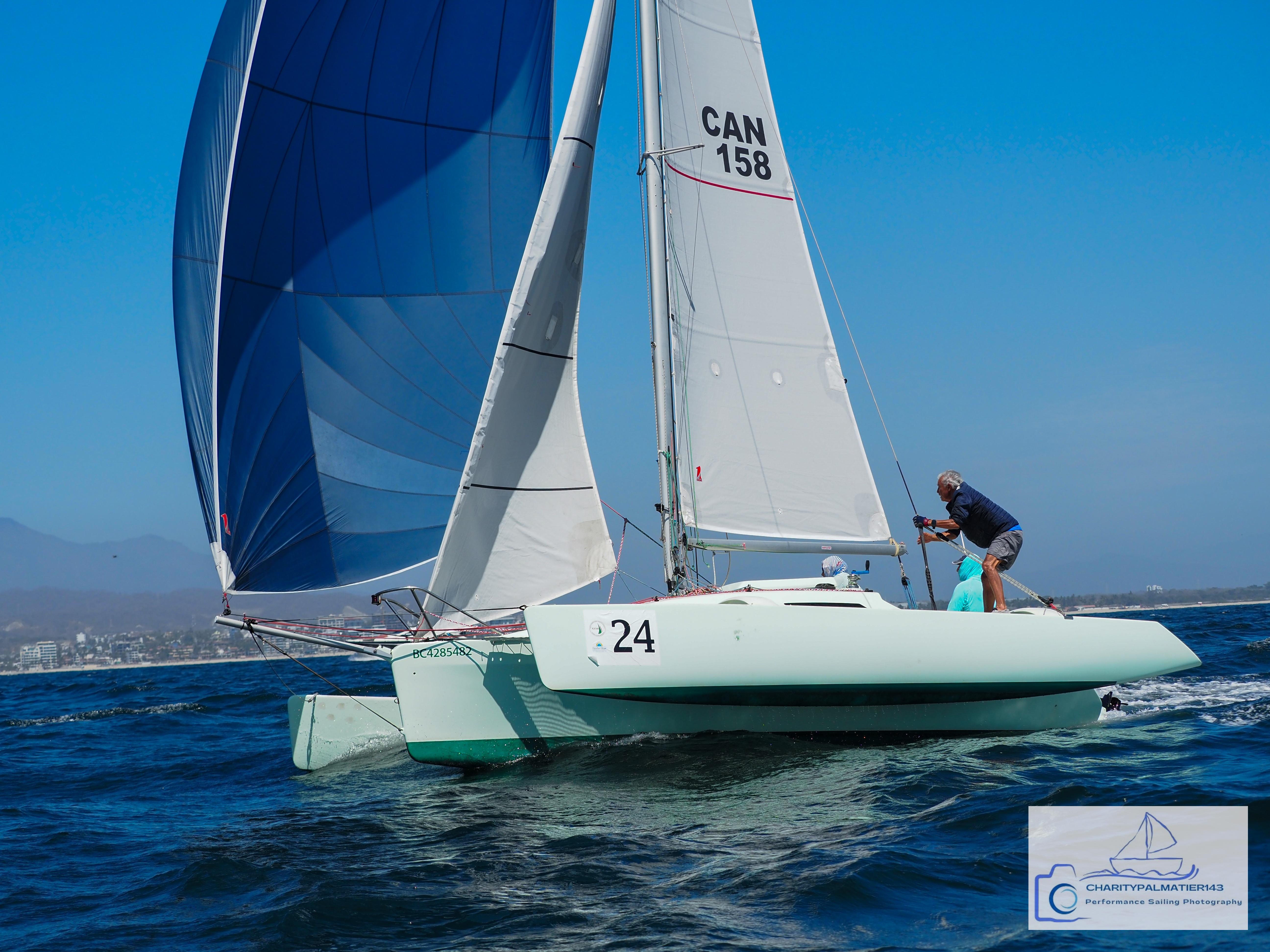 Custom Melvest Marine F-22 Sailboat "Melvest Marine F-22" racing on open water, 2011 model, with blue and white sails.
