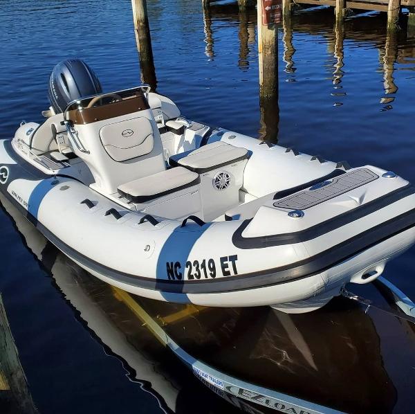 Walker Bay venture 2025 Walker Bay Venture inflatable boat docked on calm water.