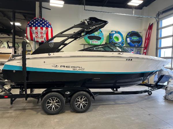 Regal LS2 Surf 2025 Regal LS2 Surf boat on trailer in showroom.
