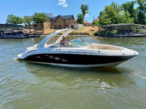 Chaparral 276 SSi 2006 Chaparral 276 SSi boat cruising on a sunny lake near waterfront homes.