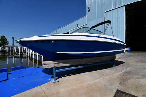 Regal 24 FasDeck 2014 Regal 24 FasDeck boat on a lift near a marina.