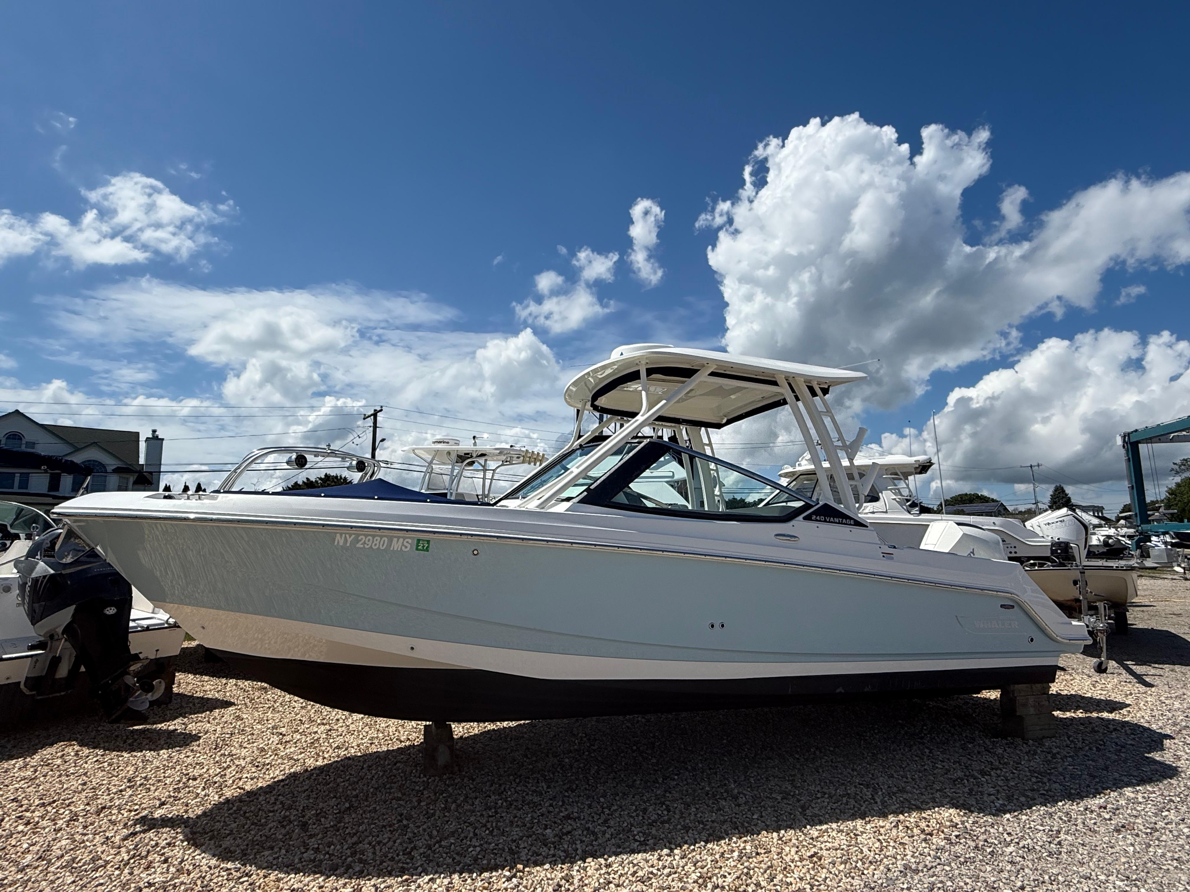 Boston Whaler 240 Vantage 2021 Boston Whaler 240 Vantage boat displayed outdoors under a blue sky.