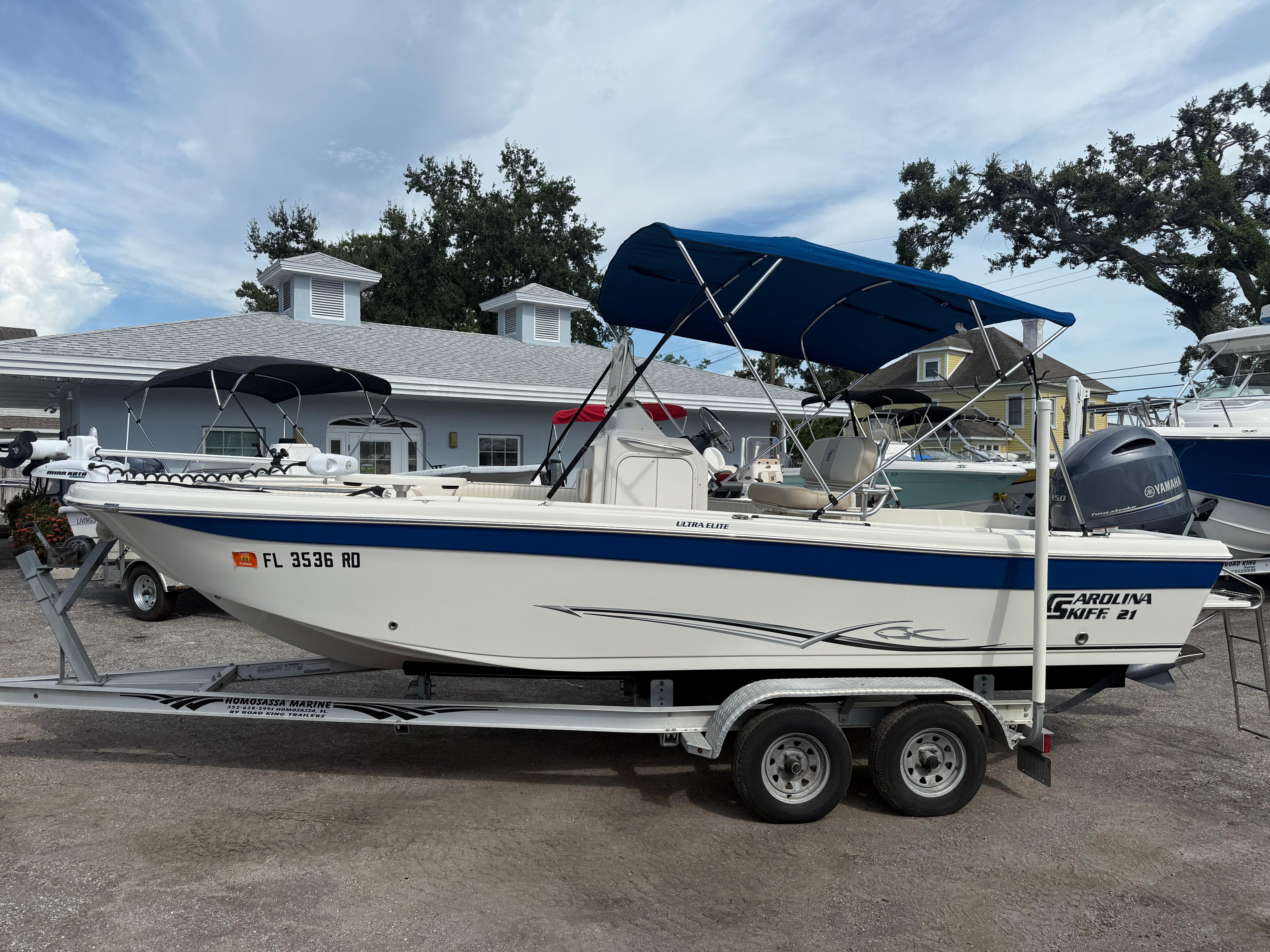 Carolina Skiff 21 Ultra Elite 2016 Carolina Skiff 21 Ultra Elite boat on trailer with blue canopy.