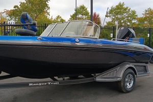 Ranger 1880MS 2024 Ranger 1880MS boat on trailer, blue and black design, parked outdoors.