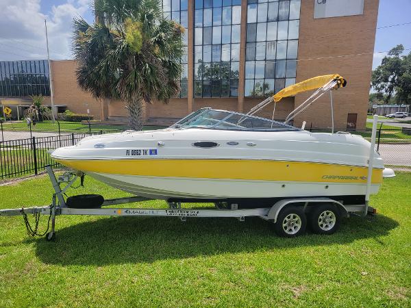 Chaparral Sunesta 214 2007 Chaparral Sunesta 214 boat on trailer, yellow and white, parked on grass.