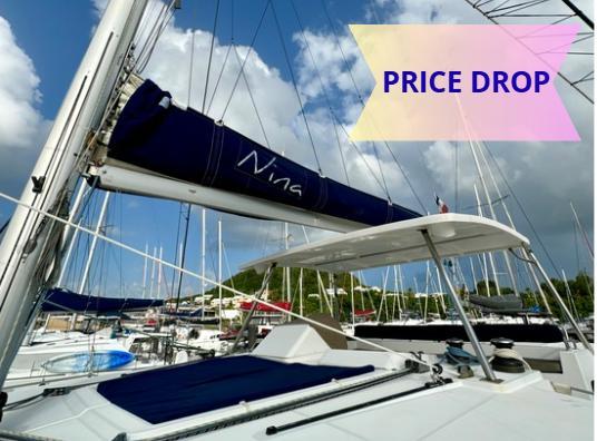 Lagoon 450 F 2012 Lagoon 450 F sailboat with price drop, docked in marina under blue sky.