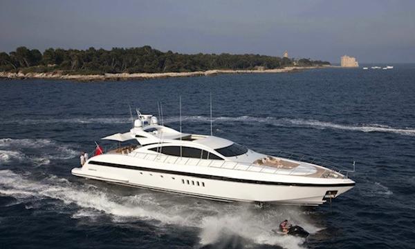 Mangusta 92 Luxury 2005 Mangusta 92 yacht cruising on open sea near scenic coastline.