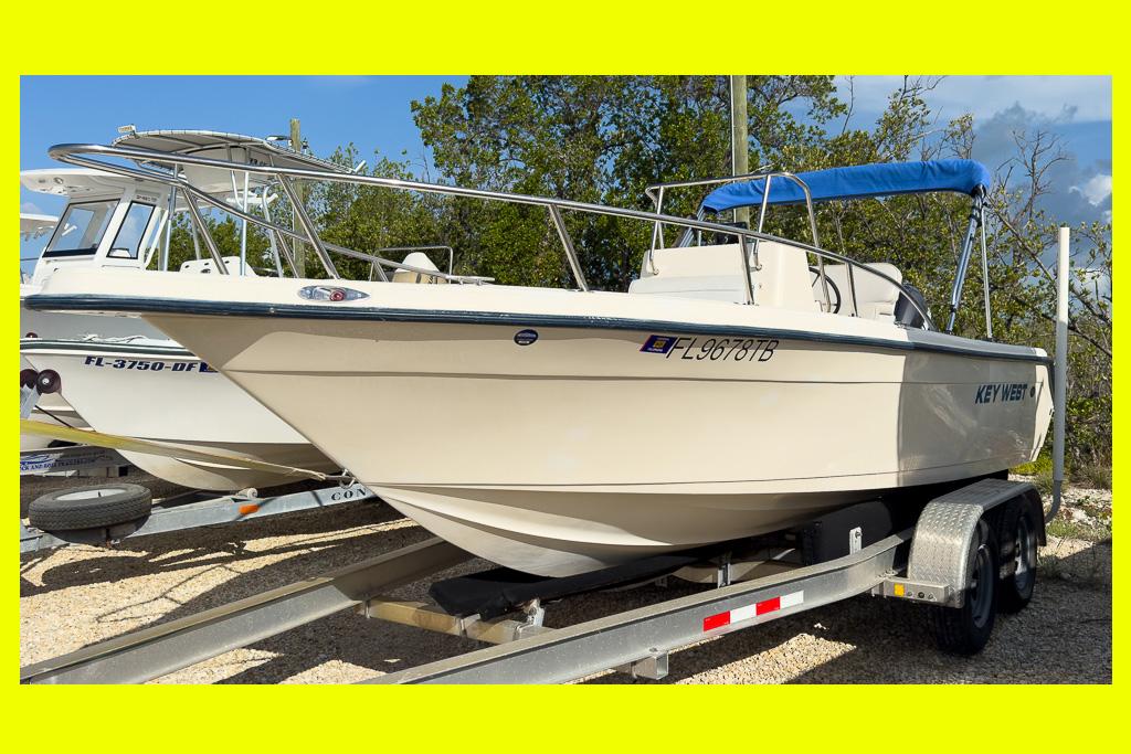 Key West 2020 Center Console 2003 Key West 2020 Center Console boat on trailer, featuring a blue canopy.