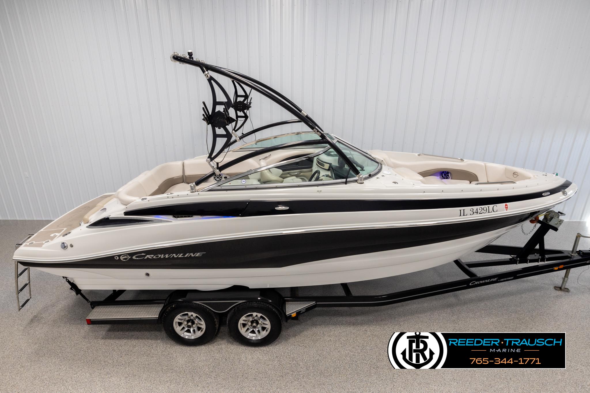Crownline 255 SS 2014 Crownline 255 SS boat on trailer in showroom, side view.