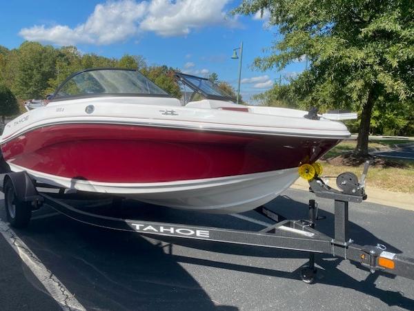 Tahoe 185 S 2024 Tahoe 185 S boat on trailer, red and white, parked outdoors.
