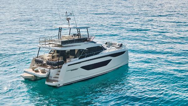Prestige M48 Luxurious 2025 Prestige M48 yacht cruising on clear blue waters.