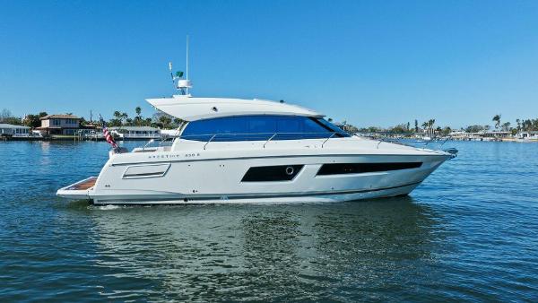 Prestige 450 S 2014 Prestige 450 S yacht cruising on calm waters under clear blue skies.
