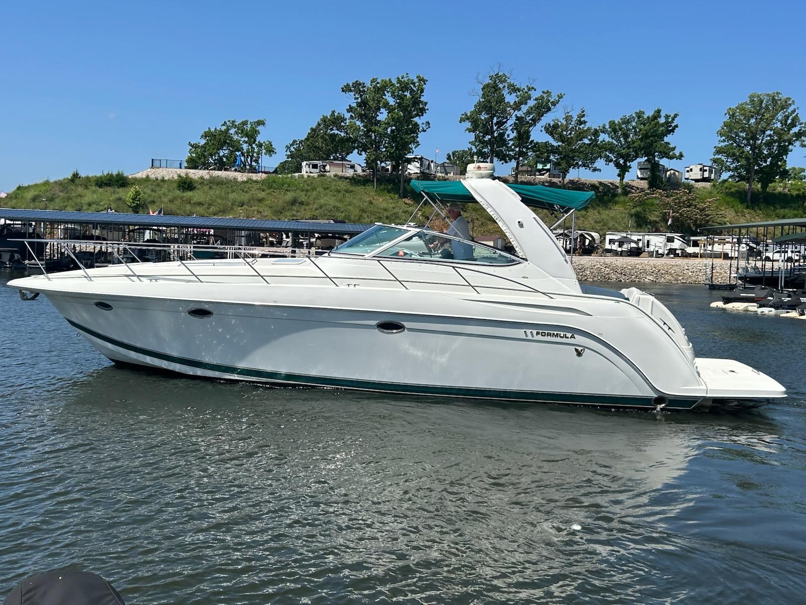 Formula 40 PC 2000 Formula 40 PC yacht cruising on a sunny day near a marina.