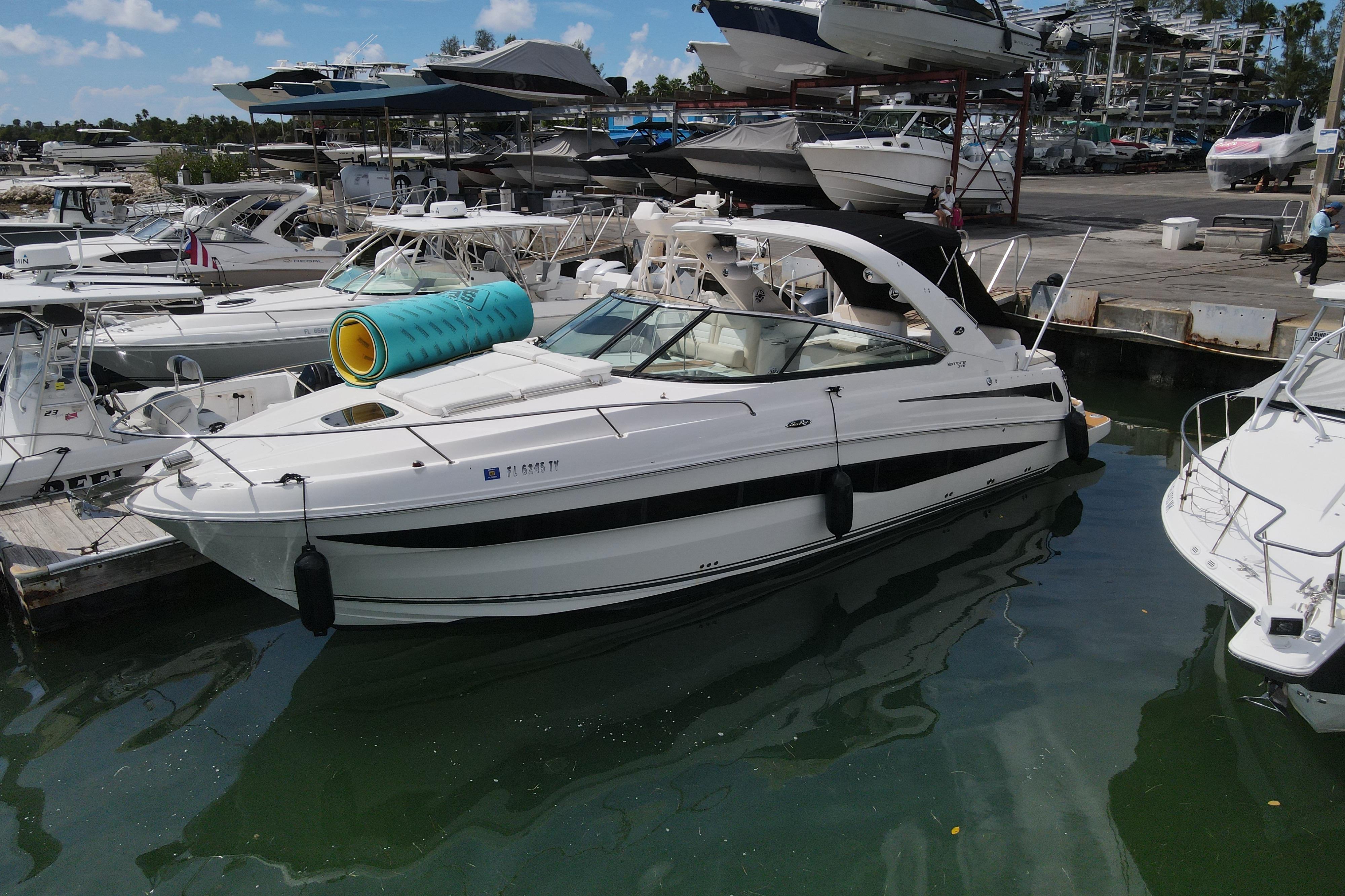 Sea Ray 370 Venture 2013 Sea Ray 370 Venture docked at marina, surrounded by other boats.
