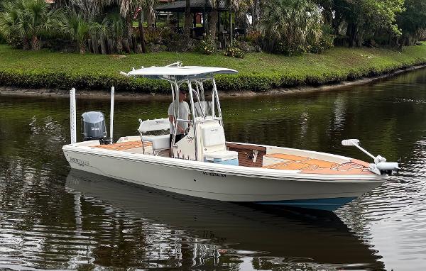 Pathfinder 2600 HPS 2020 Pathfinder 2600 HPS boat cruising on a calm river with lush greenery.