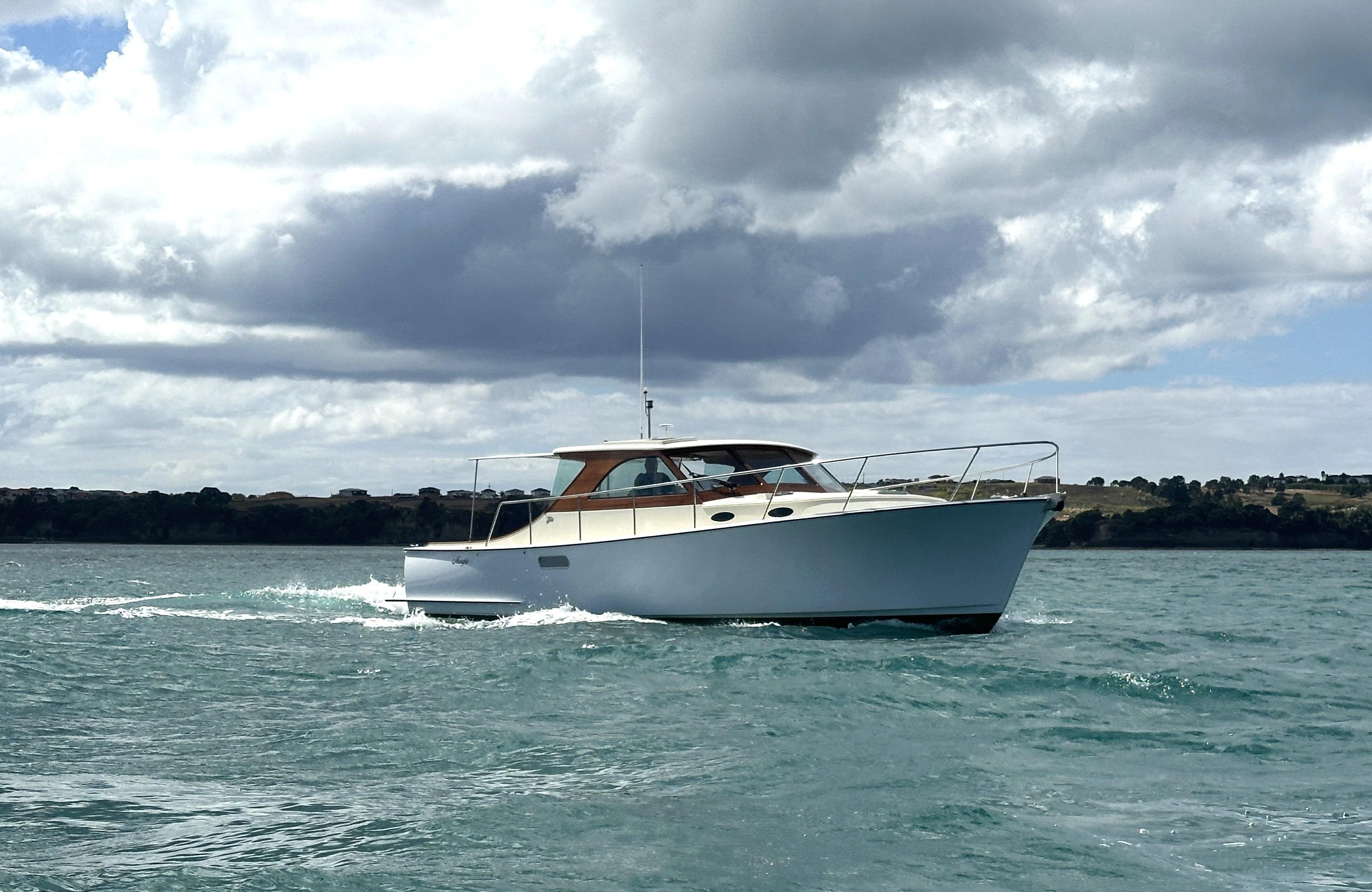 Custom Bill Upton 40 Custom Bill Upton 40 boat cruising on open water under cloudy skies, 2012 model.