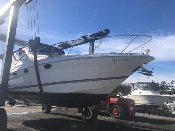 Wellcraft 3300 Martinique 2001 Wellcraft 3300 Martinique boat on lift, clear sky background.