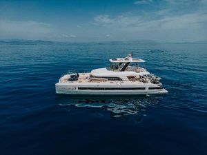Lagoon Lagoon 67 2023 Lagoon 67 yacht cruising on calm blue ocean waters.