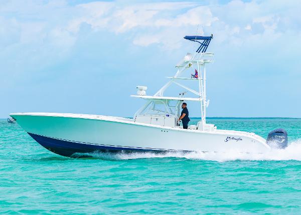 Yellowfin 42 Offshore 2011 Yellowfin 42 Offshore boat cruising on turquoise waters under a clear sky.