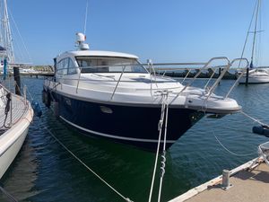 Nimbus 405 Coupé 2014 Nimbus 405 Coupé yacht docked at marina under clear blue sky.