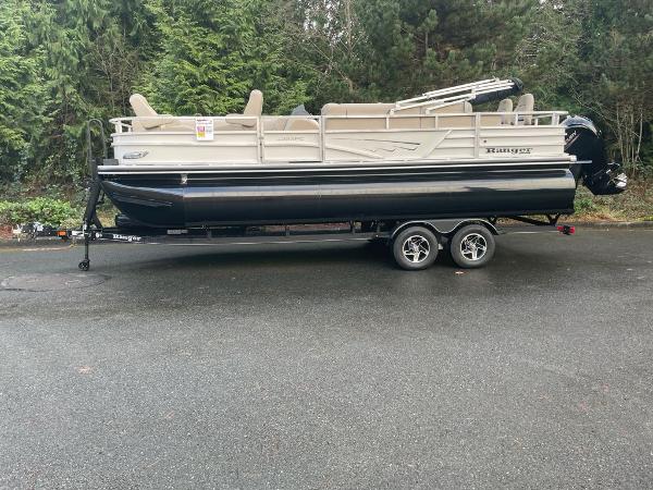 Ranger Reata 223FC 2024 Ranger Reata 223FC pontoon boat on trailer, parked outdoors.