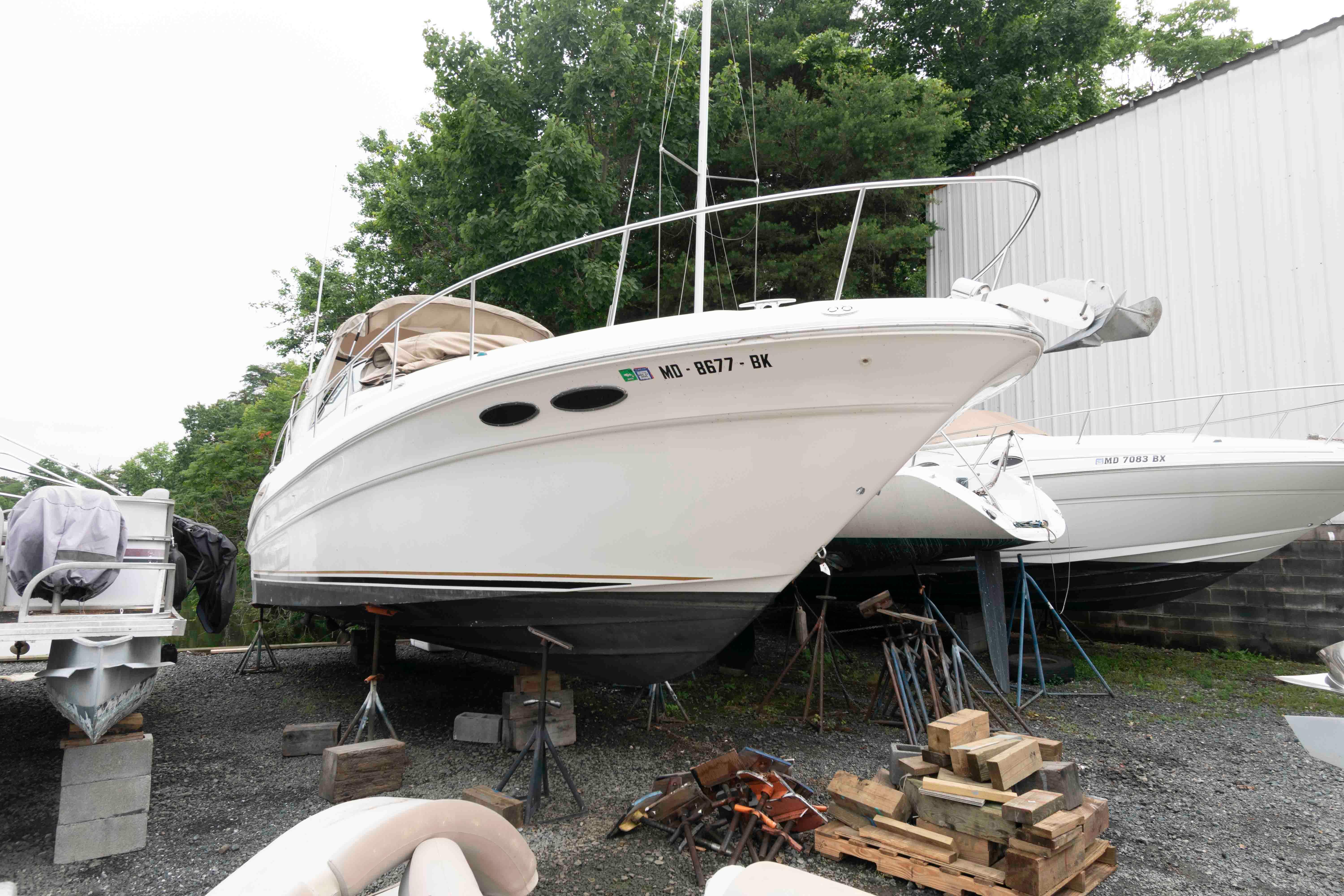 Sea Ray 340 Sundancer 2001 Sea Ray 340 Sundancer boat on dry dock, surrounded by trees and other boats.
