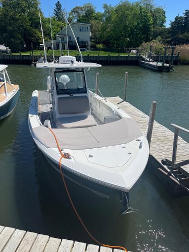 Edgewater 340CC 2021 Edgewater 340CC boat docked in a serene marina setting.