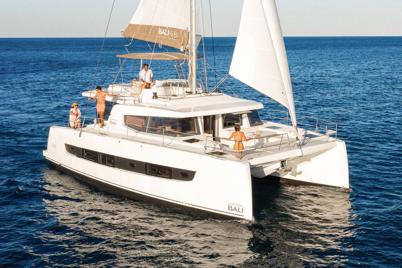 Bali 4.8 2025 Bali 4.8 catamaran sailing on open sea with people on deck.