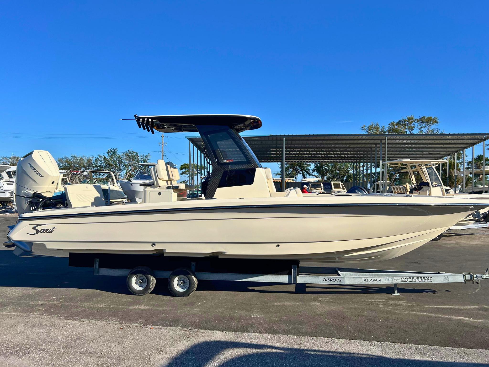 Scout 281 XSS 2025 Scout 281 XSS boat on trailer, side view under clear blue sky.