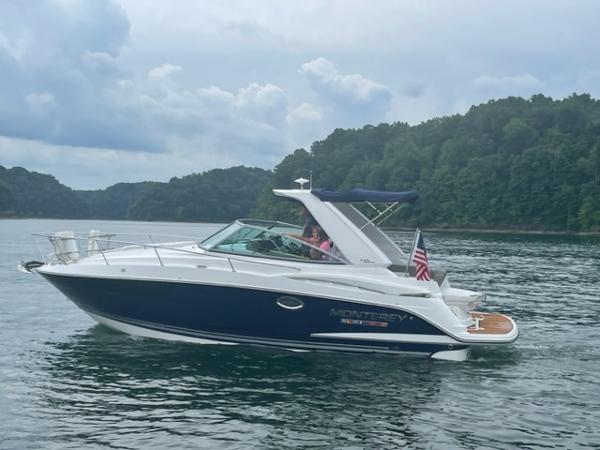 Monterey 295 Sport Yacht 2017 Monterey 295 Sport Yacht cruising on a lake with lush green shoreline.