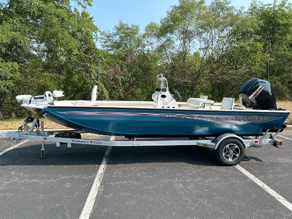 Ranger RB190 2024 Ranger RB190 boat on trailer, parked outdoors, surrounded by trees.