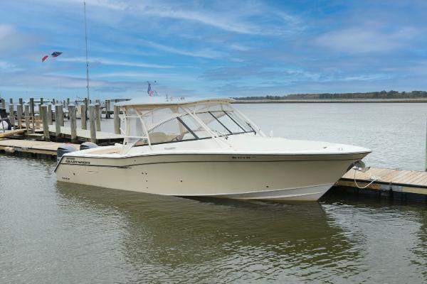 Grady-White Freedom 335 2015 Grady-White Freedom 335 boat docked by a pier under a clear blue sky.